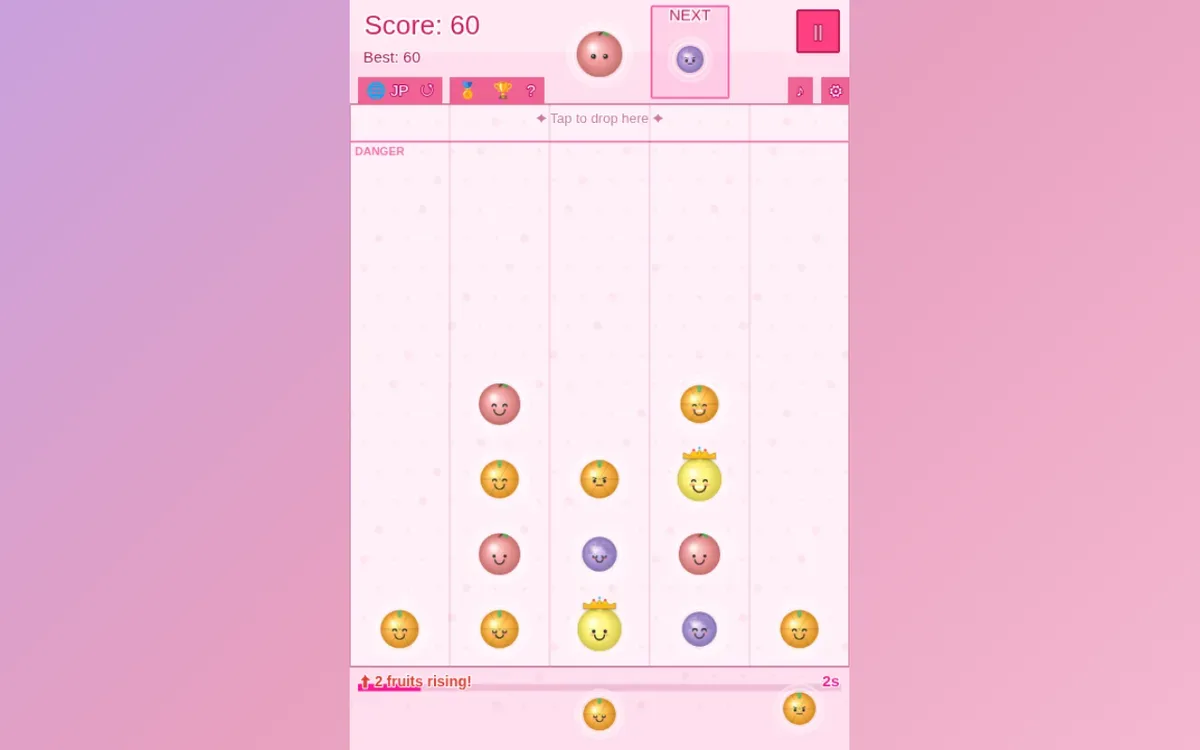 Fruit Bubble Pop desktop board with an orange fruit above a crowned yellow fruit in the fourth column.