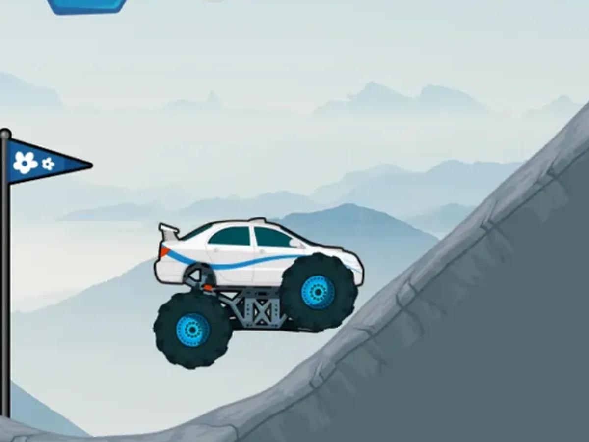 White-and-blue monster truck climbing a gray mountain slope